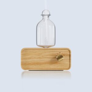 Elegant waterless diffuser on wooden table for aromatherapy
