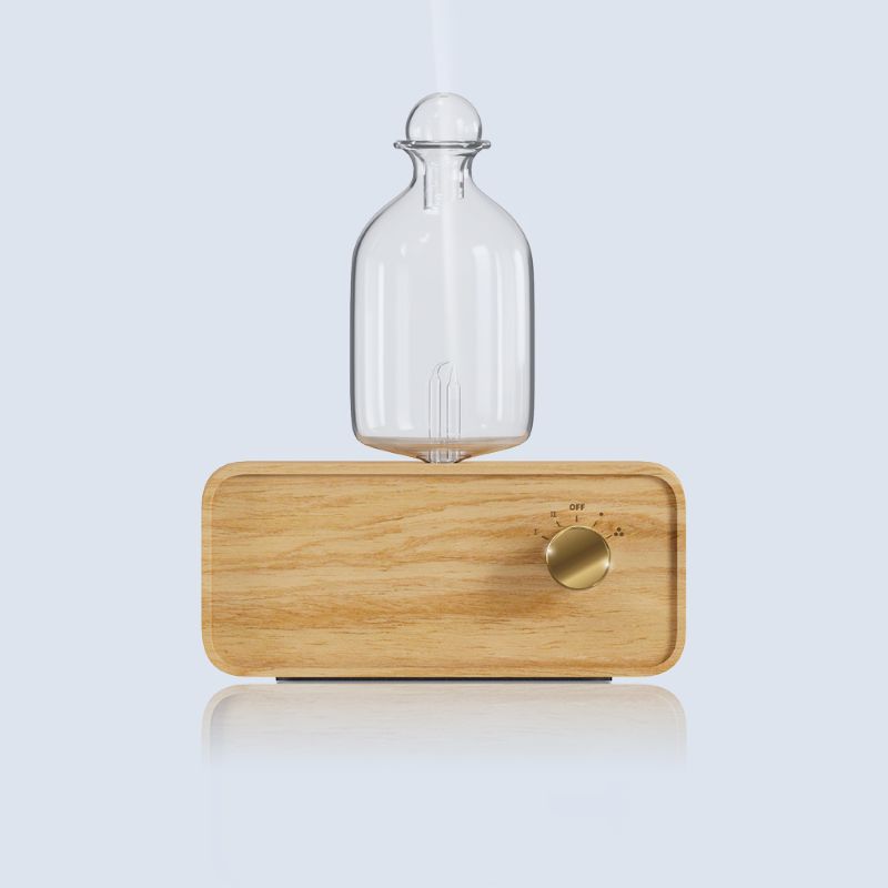 Elegant waterless diffuser on wooden table for aromatherapy